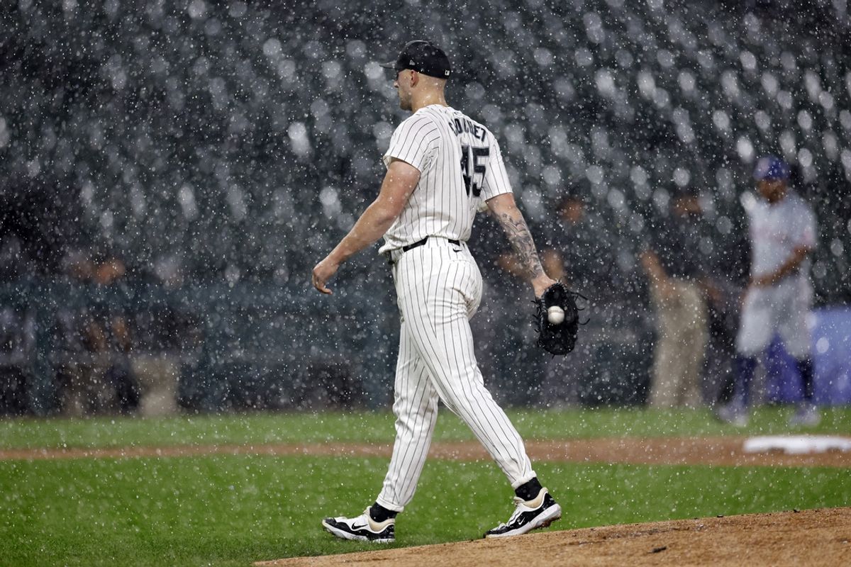 Aug 27, 2024; Chicago, Illinois, USA; Chicago White Sox starting pitcher Garrett Crochet (45) walks off the field during heavy rain in the first inning of a baseball game between the Chicago White Sox and Texas Rangers at Guaranteed Rate Field. Mandatory Credit: Kamil Krzaczynski-USA TODAY Sports
