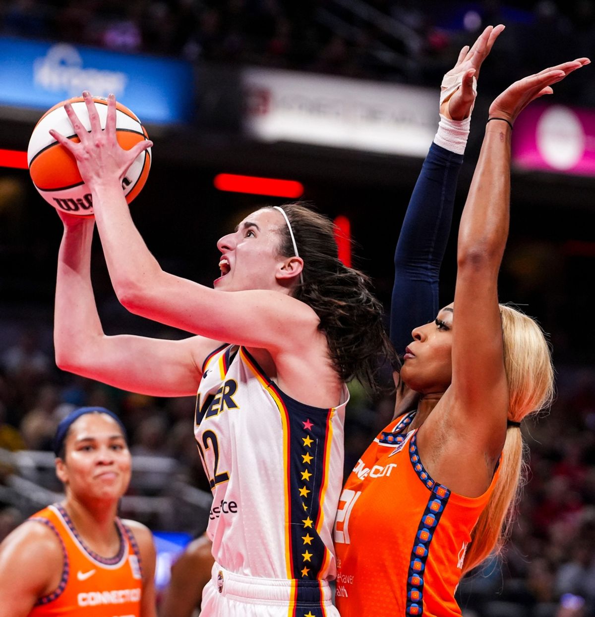 Indiana Fever guard Caitlin Clark (22) goes up for a shot against Connecticut Sun guard DiJonai Carrington (21) on Wednesday, Aug. 28, 2024, during a game between the Indiana Fever and the Connecticut Sun at Gainbridge Fieldhouse in Indianapolis.