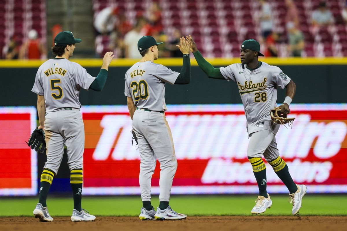 Aug 28, 2024; Cincinnati, Ohio, USA; Oakland Athletics outfielder Daz Cameron (28) high fives second baseman Zack Gelof (20) after the victory over the Cincinnati Reds at Great American Ball Park. Mandatory Credit: Katie Stratman-USA TODAY Sports