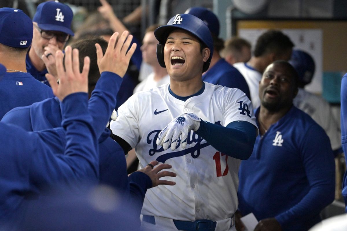 Aug 28, 2024; Los Angeles, California, USA;  Los Angeles Dodgers designated hitter Shohei Ohtani (17) is congratulated in the dugout after hitting a solo home run in the first inning against the Baltimore Orioles at Dodger Stadium. Mandatory Credit: Jayne Kamin-Oncea-USA TODAY Sports