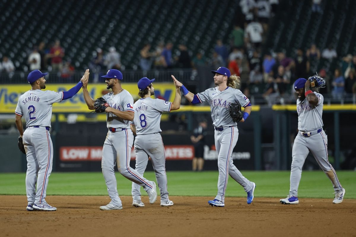 Aug 28, 2024; Chicago, Illinois, USA; Texas Rangers players celebrate after defeating the Chicago White Sox in game two of the doubleheader at Guaranteed Rate Field. Mandatory Credit: Kamil Krzaczynski-USA TODAY Sports