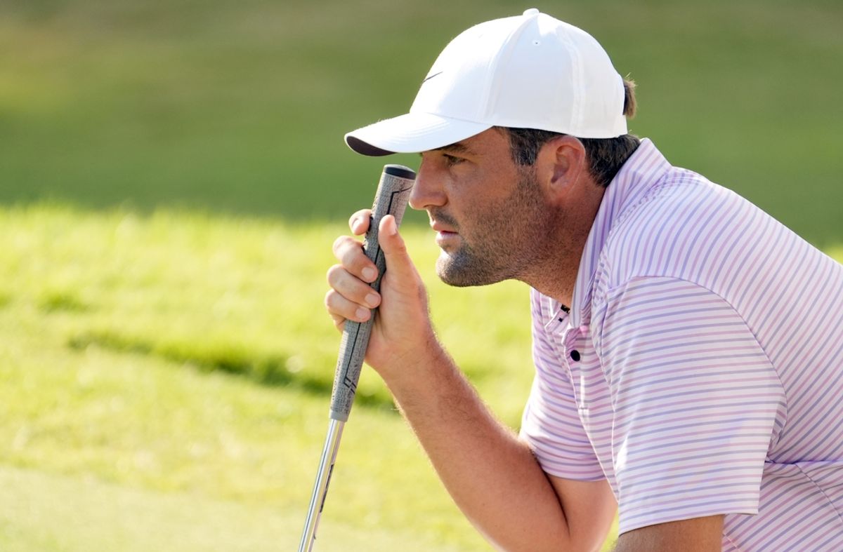 Aug 29, 2024; Atlanta, Georgia, USA; Scottie Scheffler looks over his putt on the 18th green during the first round of the TOUR Championship golf tournament. Mandatory Credit: John David Mercer-USA TODAY Sports