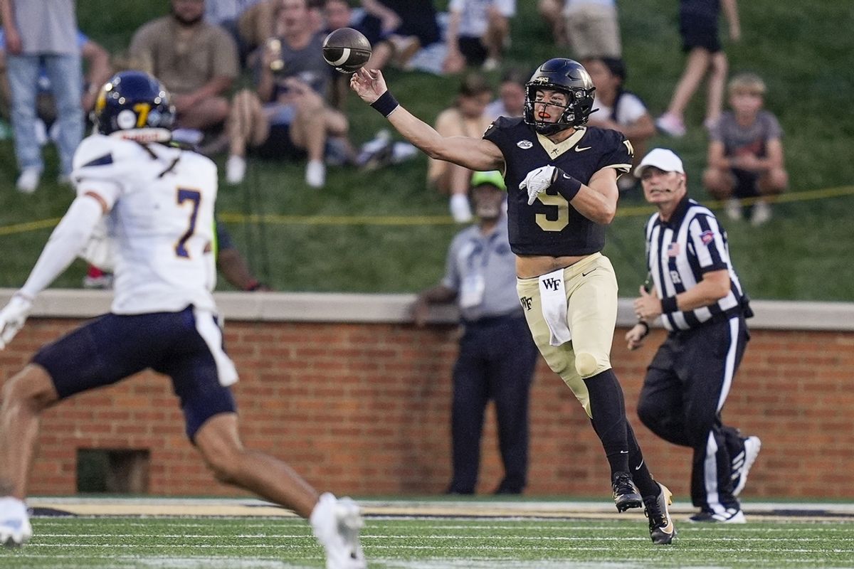 Aug 29, 2024; Winston-Salem, North Carolina, USA;  Wake Forest Demon Deacons quarterback Hank Bachmeier (9) passes the ball under duress from North Carolina A&T Aggies safety David Laney (7) during the first half at Allegacy Federal Credit Union Stadium. Mandatory Credit: Jim Dedmon-USA TODAY Sports