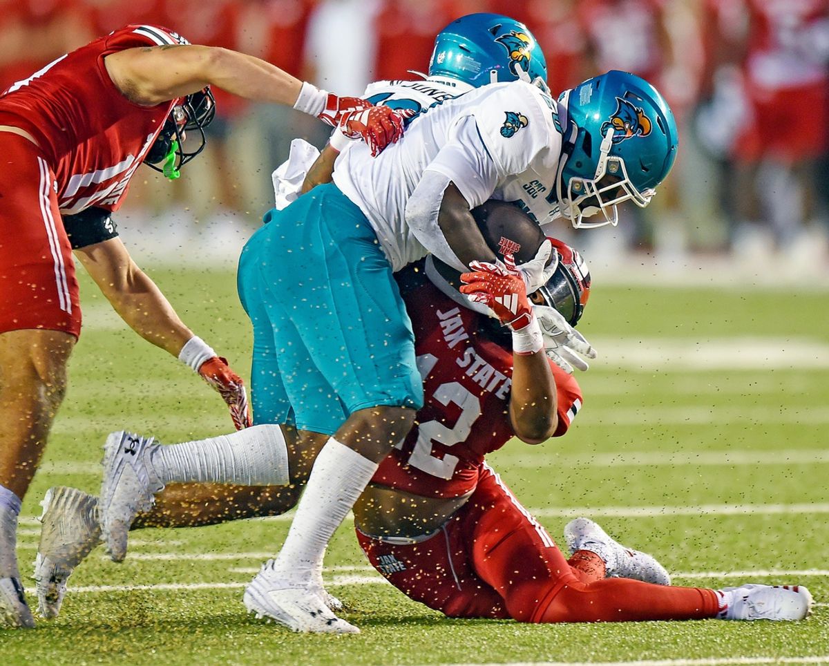 Coastal Carolina's Christian Washington tries to evade the tackle of Jacksonville State's Malcolm Jones during college football action at Burgess-Snow Field AmFirst Stadium in Jacksonville, Alabama August 29, 2024. (Dave Hyatt / Special to the Gadsden Times)