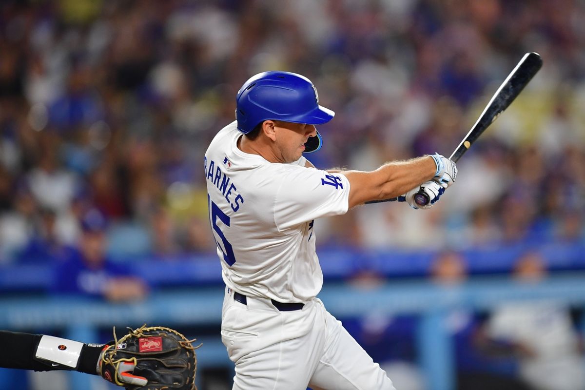 Aug 29, 2024; Los Angeles, California, USA; Los Angeles Dodgers catcher Austin Barnes (15) hits a two run RBI double against the Baltimore Orioles during the fourth inning at Dodger Stadium. Mandatory Credit: Gary A. Vasquez-USA TODAY Sports
