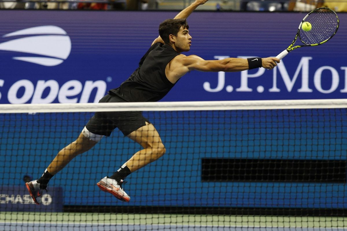 Aug 29, 2024; Flushing, NY, USA; Carlos Alcaraz (ESP) reaches for, toppic a volley against Botic van De Zandschlup (NED)(not pictured) in a men's singles match on day four of the 2024 U.S. Open tennis tournament at Billie Jean King National Tennis Center. Mandatory Credit: Geoff Burke-Imagn Images