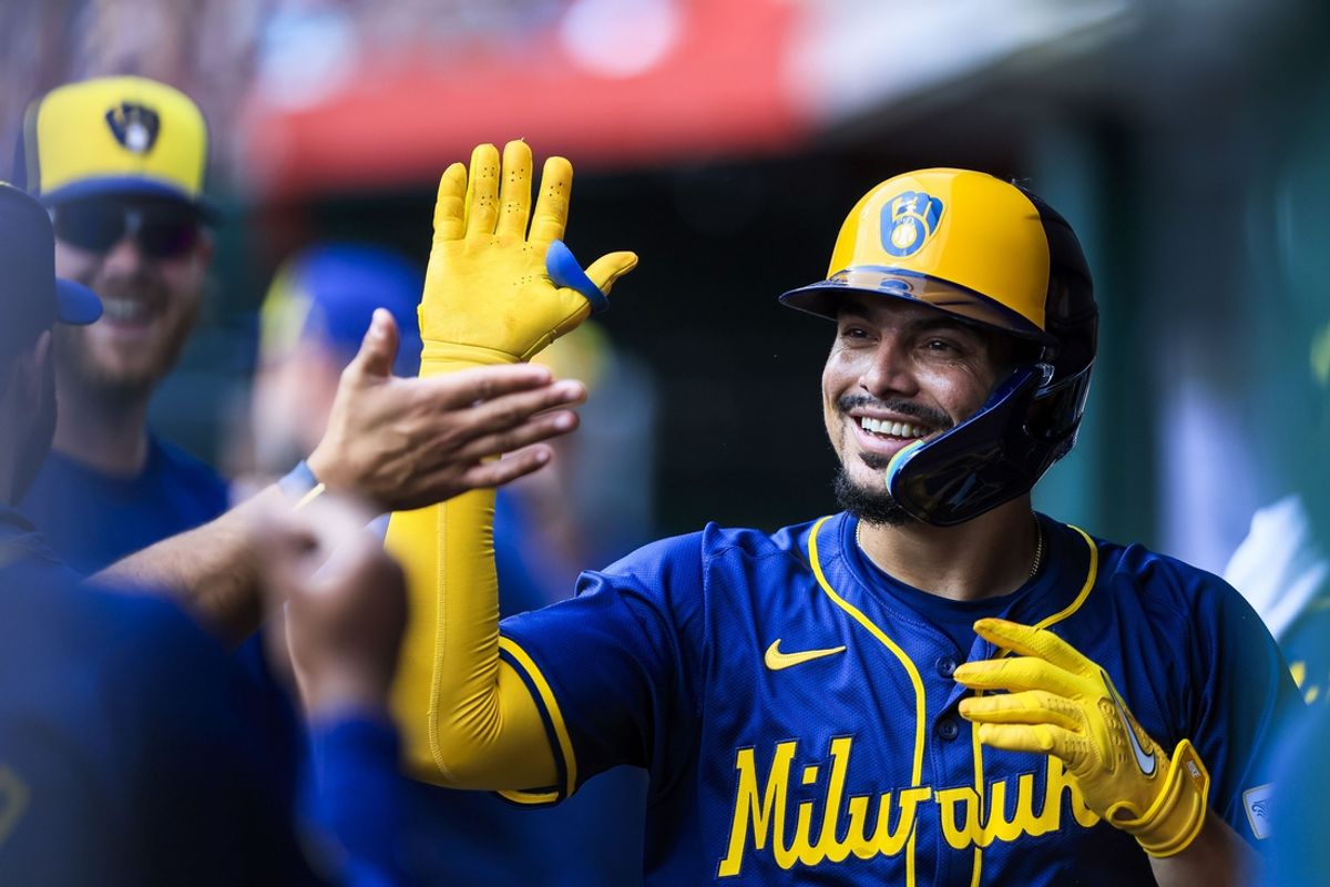 Aug 30, 2024; Cincinnati, Ohio, USA; Milwaukee Brewers shortstop Willy Adames (27) high fives teammates after hitting a solo home run in the second inning against the Cincinnati Reds at Great American Ball Park. Mandatory Credit: Katie Stratman-USA TODAY Sports