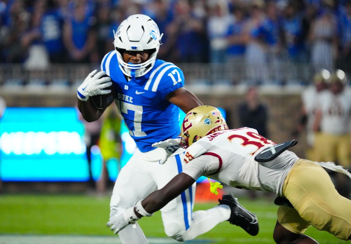 Aug 30, 2024; Durham, North Carolina, USA;  Duke Blue Devils running back Star Thomas (17) runs with the ball against Elon Phoenix defensive back DJ Hamilton (38) during the first half at Wallace Wade Stadium. Mandatory Credit: James Guillory-USA TODAY Sports