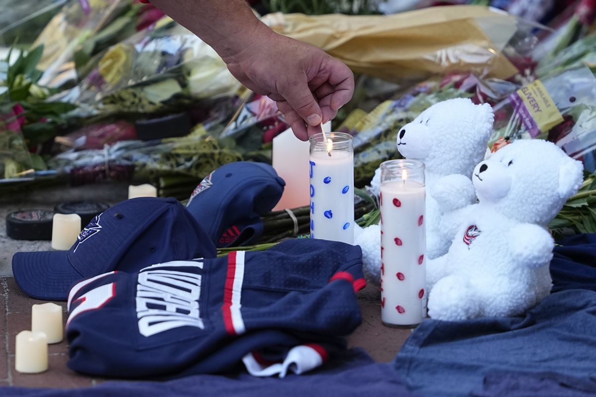 Aug 30, 2024; Columbus, OH, USA; Mourners light candles outside Nationwide Arena at a makeshift memorial for Columbus Blue Jackets forward Johnny Gaudreau. Gaudreau and his brother, Matthew, were killed in a bicycle accident the night before. Mandatory Credit: Adam Cairns/Columbus Dispatch-USA TODAY Network