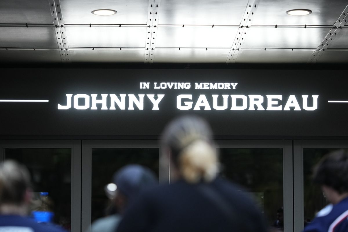 Aug 30, 2024; Columbus, OH, USA; Mourners gather outside Nationwide Arena at a makeshift memorial for Columbus Blue Jackets forward Johnny Gaudreau. Gaudreau and his brother, Matthew, were killed in a bicycle accident the night before. Mandatory Credit: Adam Cairns/Columbus Dispatch-USA TODAY Network