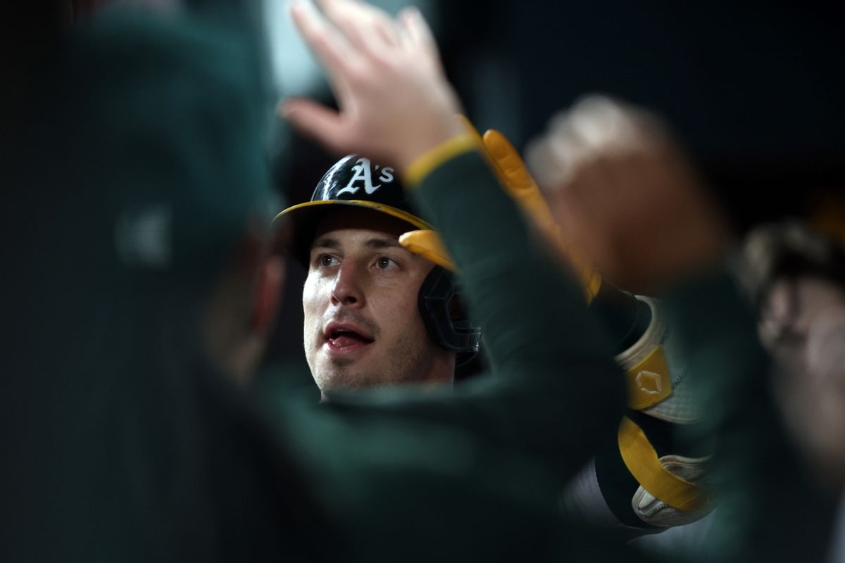 Aug 30, 2024; Arlington, Texas, USA; Oakland Athletics outfielder Brent Rooker (25) is congratulated in the dugout after hitting his second home run of the game against the Texas Rangers  in the seventh inning at Globe Life Field. Mandatory Credit: Tim Heitman-USA TODAY Sports