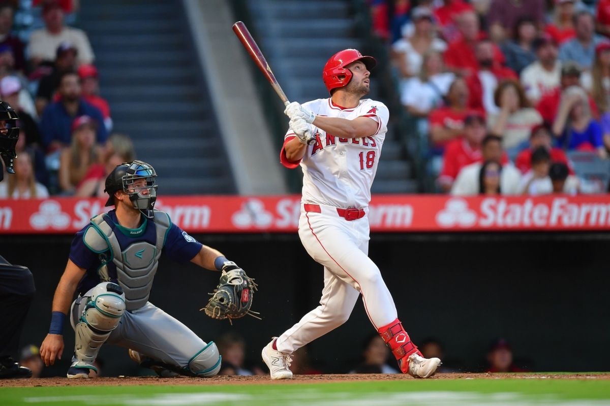 Aug 30, 2024; Anaheim, California, USA;Los Angeles Angels first baseman Nolan Schanuel (18) hits a sacrifice RBI against the Seattle Mariners during the first inning  at Angel Stadium. Mandatory Credit: Gary A. Vasquez-Imagn Images