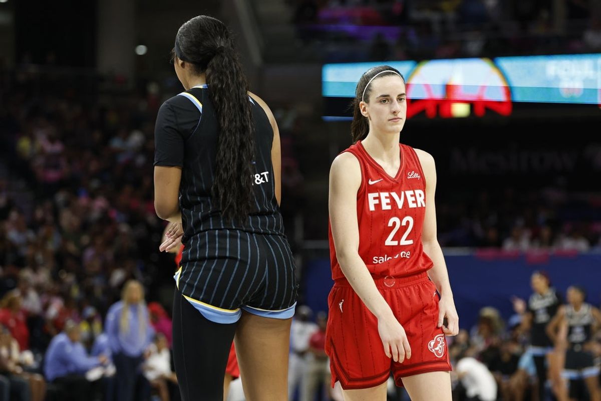 Aug 30, 2024; Chicago, Illinois, USA; Indiana Fever guard Caitlin Clark (22) walks by Chicago Sky forward Angel Reese (5) during the second half at Wintrust Arena. Mandatory Credit: Kamil Krzaczynski-Imagn Images
