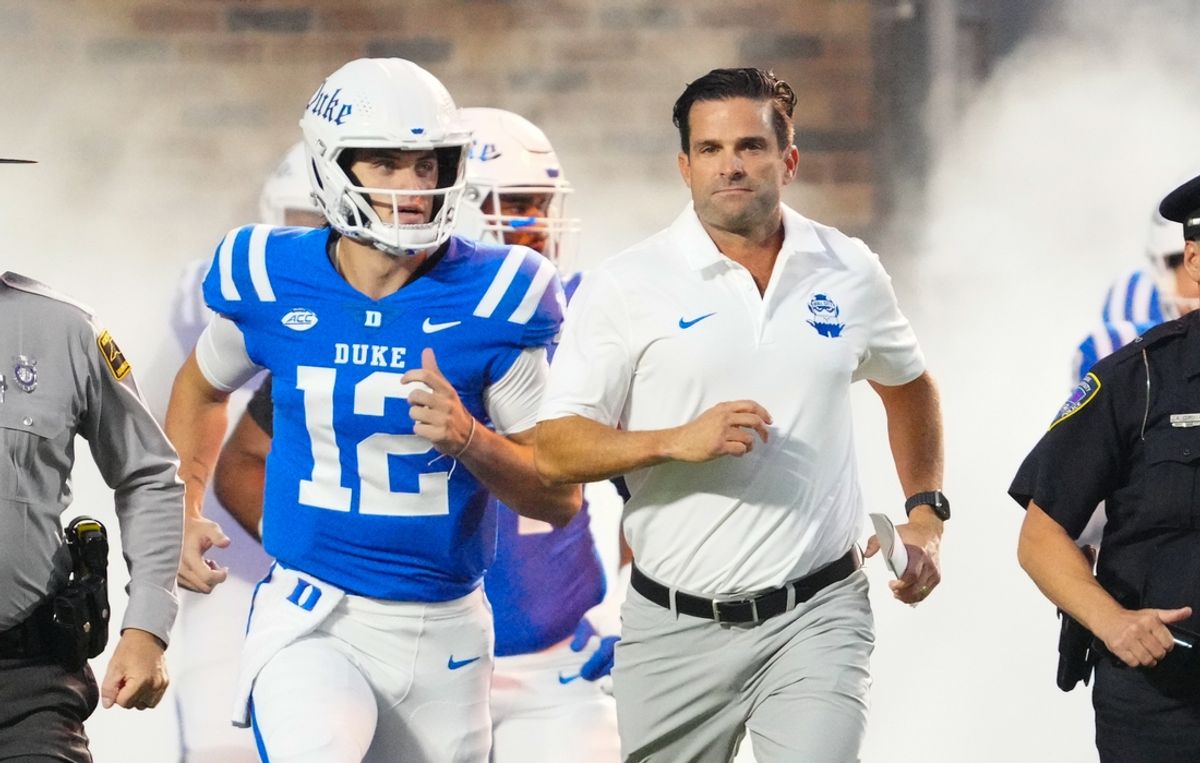 Aug 30, 2024; Durham, North Carolina, USA;  Duke Blue Devils head coach Manny Diaz runs out onto the field before the game against the Elon Phoenix at Wallace Wade Stadium. Mandatory Credit: James Guillory-Imagn Images