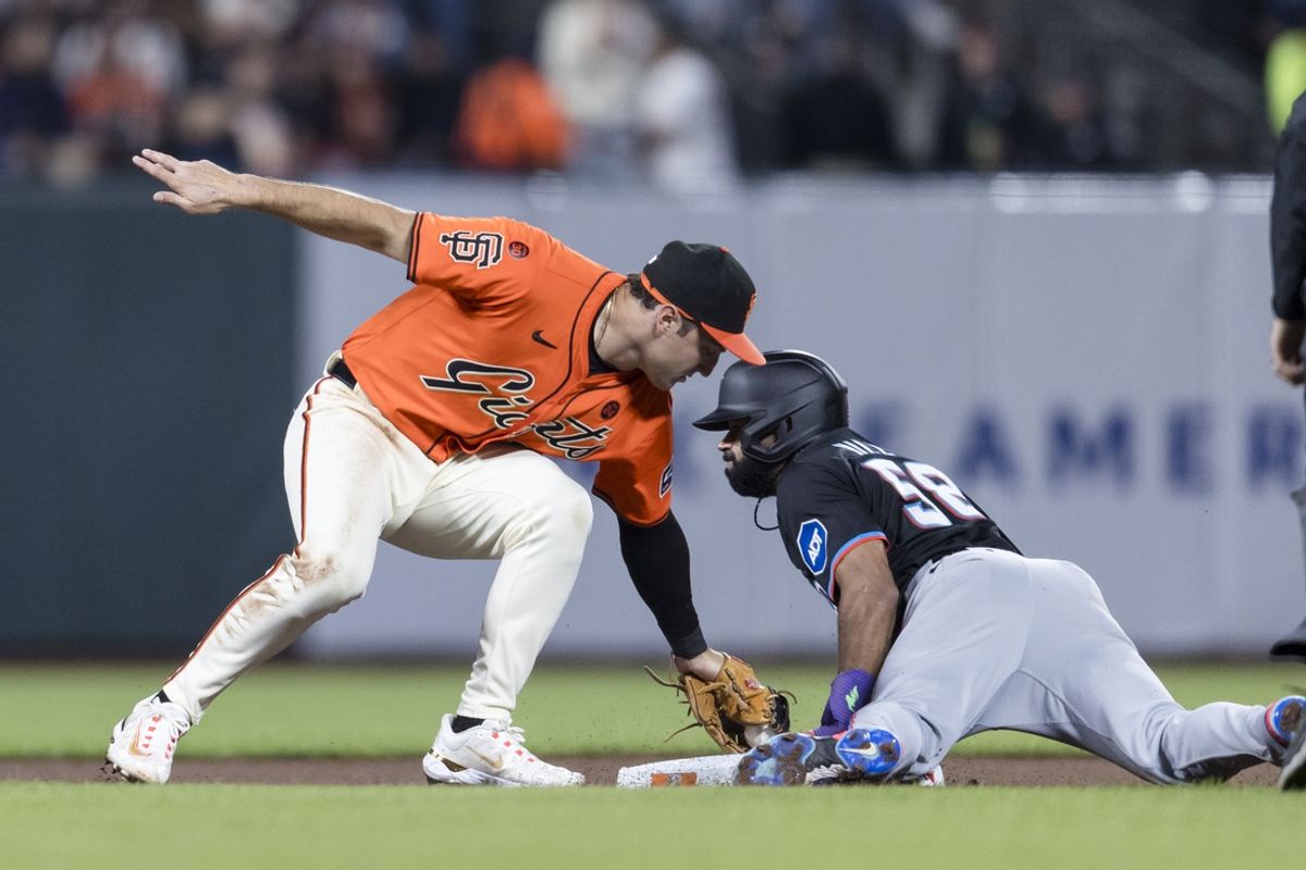 Aug 30, 2024; San Francisco, California, USA; Miami Marlins left fielder Derek Hill (58) steals second base as San Francisco Giants second baseman Casey Schmitt (10) is late on the tag during the seventh inning at Oracle Park. Mandatory Credit: John Hefti-USA TODAY Sports
