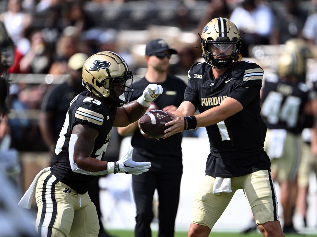 Aug 31, 2024; West Lafayette, Indiana, USA; Purdue Boilermakers quarterback Hudson Card (1) hands the ball off to Purdue Boilermakers running back Reggie Love III (23) during warm ups before the game against the Indiana State Sycamores at Ross-Ade Stadium. Mandatory Credit: Marc Lebryk-USA TODAY Sports