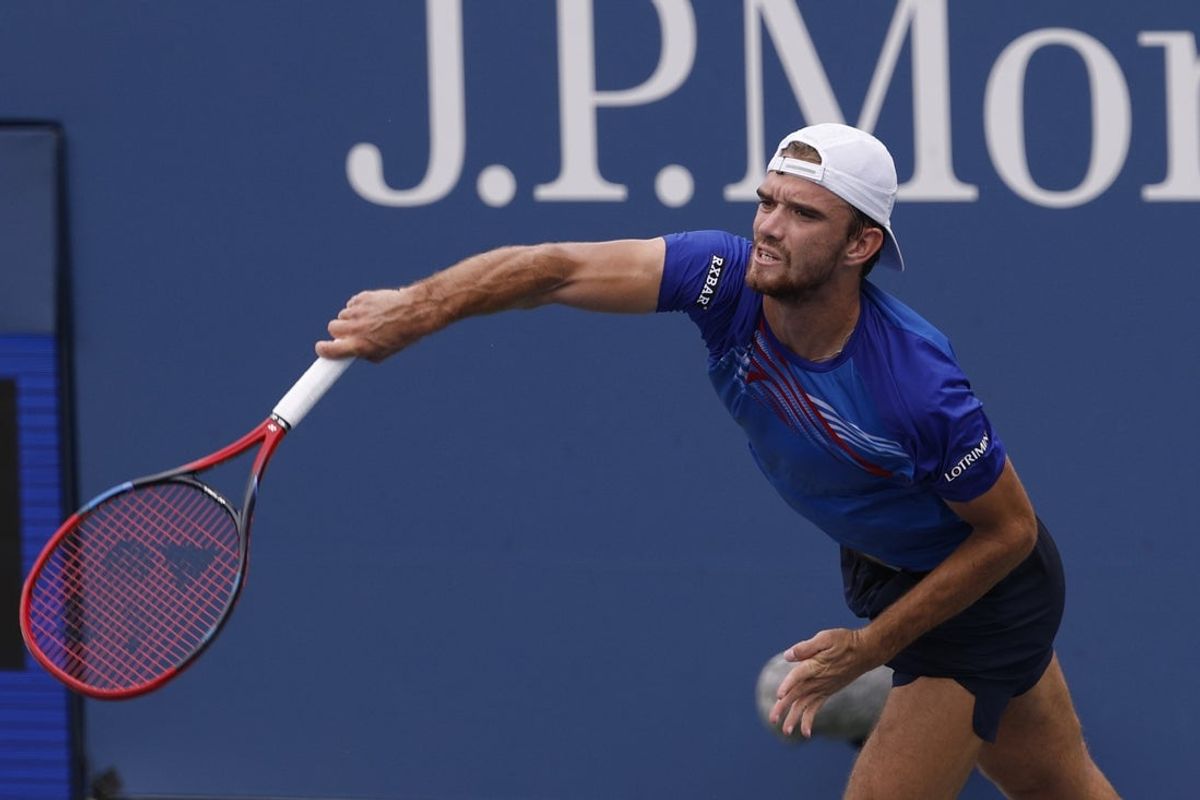 Aug 31, 2024; Flushing, NY, USA; Tomas Machac (CZE) serves against David Goffin (BEL)(not pictured) in a men's singles match on day six of the 2024 U.S. Open tennis tournament at USTA Billie Jean King National Tennis Center. Mandatory Credit: Geoff Burke-Imagn Images