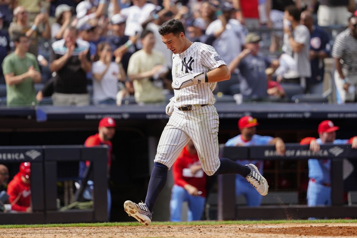 Aug 31, 2024; Bronx, New York, USA; New York Yankees shortstop Anthony Volpe (11) scores a run on New York Yankees designated hitter Giancarlo Stanton (not pictured) RBI double against the St. Louis Cardinals during the eighth inning at Yankee Stadium. Mandatory Credit: Gregory Fisher-USA TODAY Sports