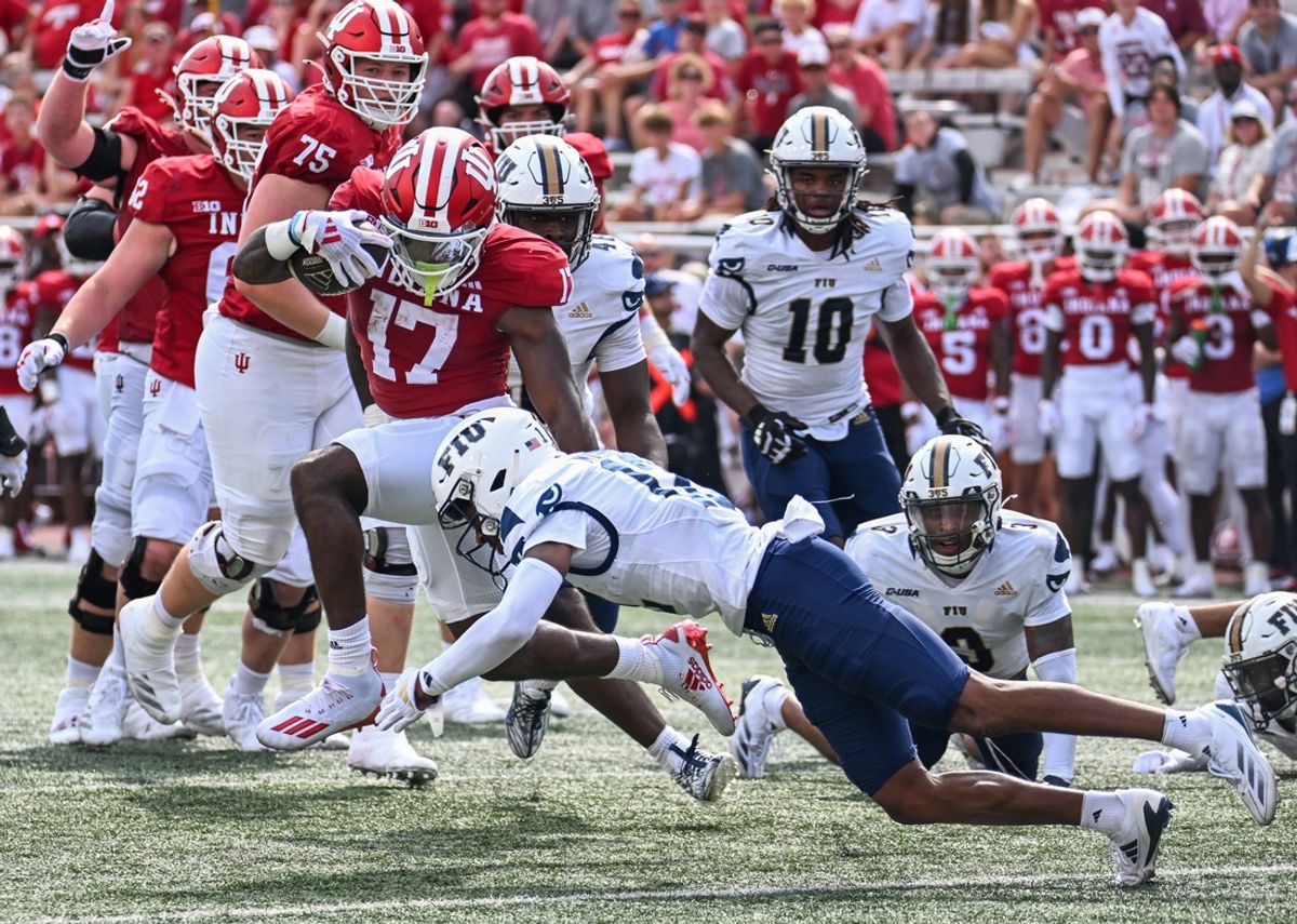 Aug 31, 2024; Bloomington, Indiana, USA;  Indiana Hoosiers running back Ty Son Lawton (17) runs for a touchdown against Florida International Panthers defensive back Hezekiah Masses (12) during the first half at Memorial Stadium. Mandatory Credit: Robert Goddin-USA TODAY Sports