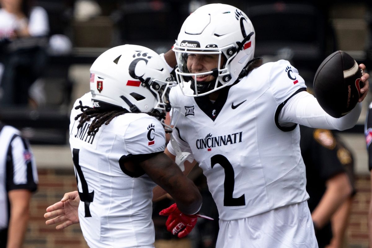 Cincinnati Bearcats quarterback Brendan Sorsby (2) reacts with Cincinnati Bearcats wide receiver Tyrin Smith (4) after scoring a touchdown in the first quarter of the College Football game between the Cincinnati Bearcats and the Towson Tigers at Nippert Stadium in Cincinnati on Saturday, Aug. 31, 2024.