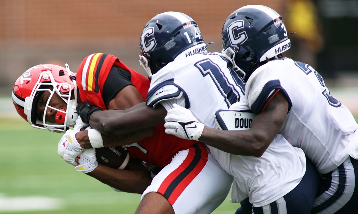 Aug 31, 2024; College Park, Maryland, USA; Maryland Terrapins wide receiver Kaden Prather (1) is tackled by Connecticut Huskies defensive backs Malcolm Bell (14) and D'Mon Brinson (3) during the third quarter against the third quarter at SECU Stadium. Mandatory Credit: Daniel Kucin Jr.-Imagn Images