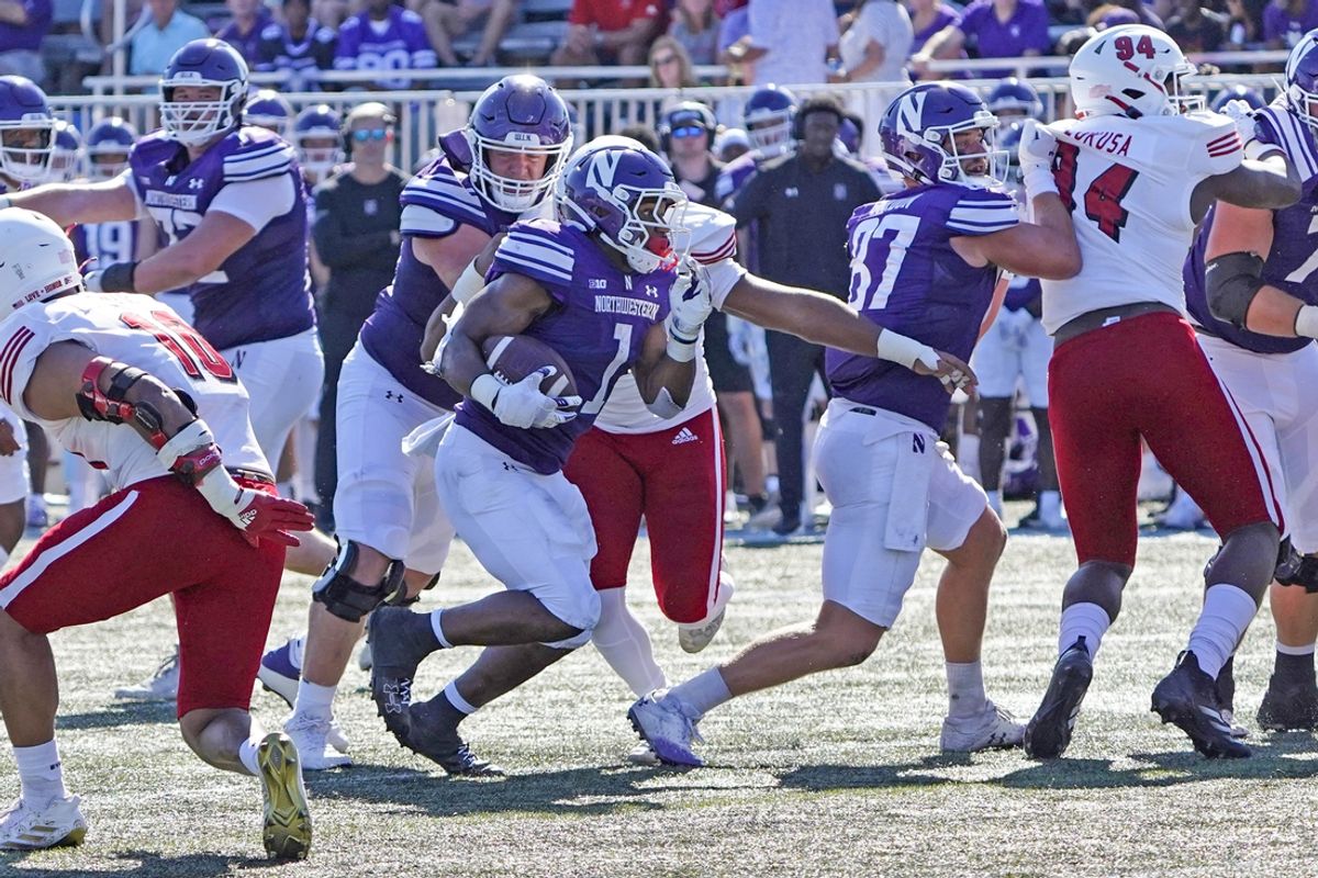 Aug 31, 2024; Evanston, Illinois, USA; Northwestern Wildcats running back Cam Porter (1) runs against the Miami (Oh) Redhawks during the first half at Lanny and Sharon Martin Stadium. Mandatory Credit: David Banks-USA TODAY Sports