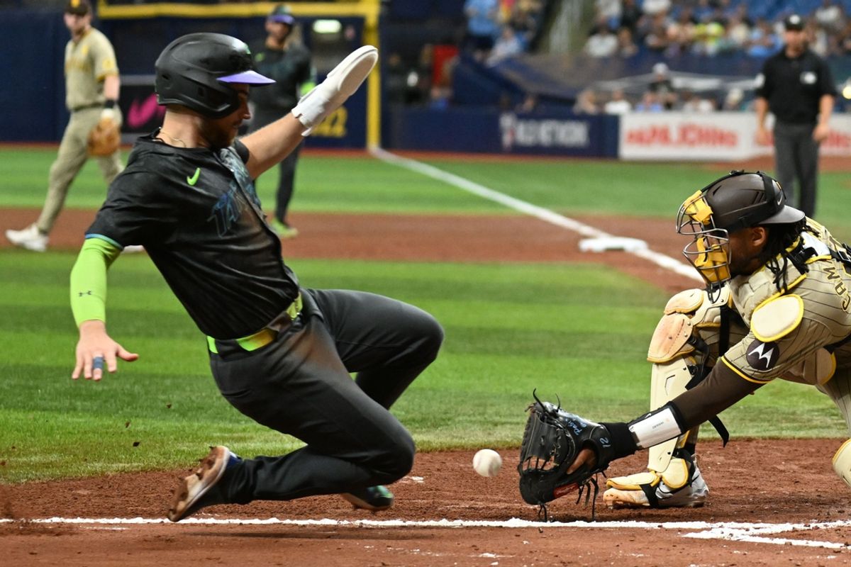Aug 31, 2024; St. Petersburg, Florida, USA; Tampa Bay Rays first baseman Brandon Lowe (8) slides safe at home as San Diego Padres catcher Kyle Higashioka (20) waits for the ball in the fourth inning  at Tropicana Field. Mandatory Credit: Jonathan Dyer-USA TODAY Sports