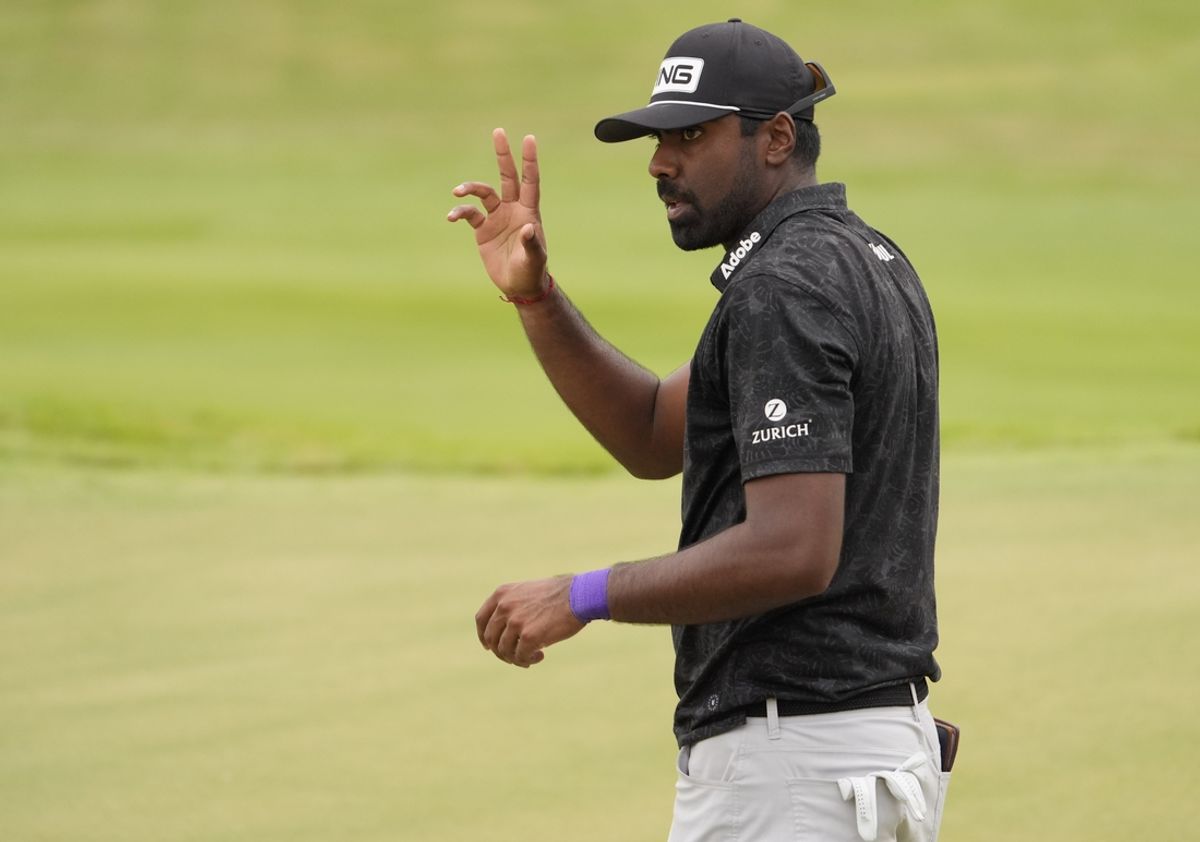 Aug 31, 2024; Atlanta, Georgia, USA; Sahith Theegala acknowledges the gallery after his putt on the 18th green during the third round of the TOUR Championship golf tournament. Mandatory Credit: John David Mercer-USA TODAY Sports