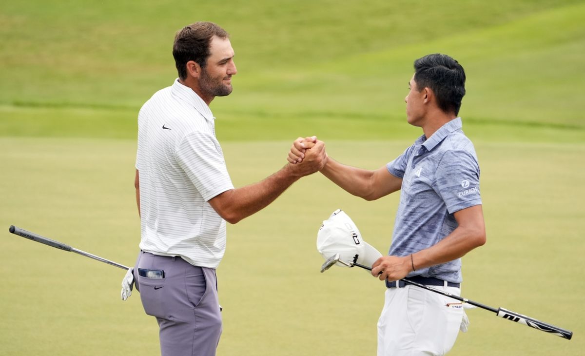 Aug 31, 2024; Atlanta, Georgia, USA; Scottie Scheffler shakes hands with Collin Morikawa on the 18th green after their third round of the TOUR Championship golf tournament. Mandatory Credit: John David Mercer-USA TODAY Sports