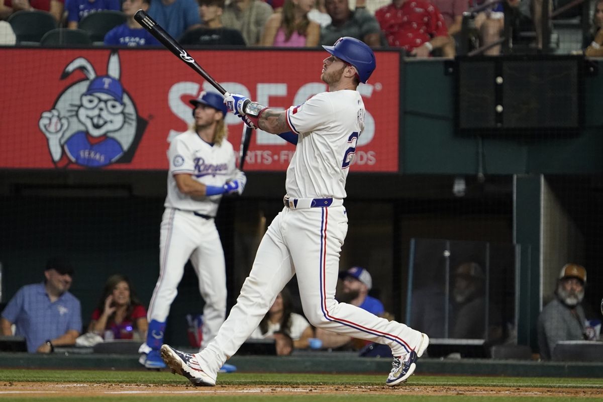 Aug 31, 2024; Arlington, Texas, USA; Texas Rangers catcher Jonah Heim (28) hits a two-run home run during the second inning against the Oakland Athletics at Globe Life Field. Mandatory Credit: Raymond Carlin III-USA TODAY Sports