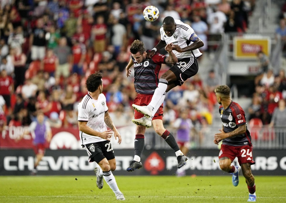 Aug 31, 2024; Toronto, Ontario, CAN; D.C. United forward Christian Benteke (20) battles for a header against Toronto FC defender Kevin Long (5) during the first half at BMO Field. Mandatory Credit: Kevin Sousa-USA TODAY Sports
