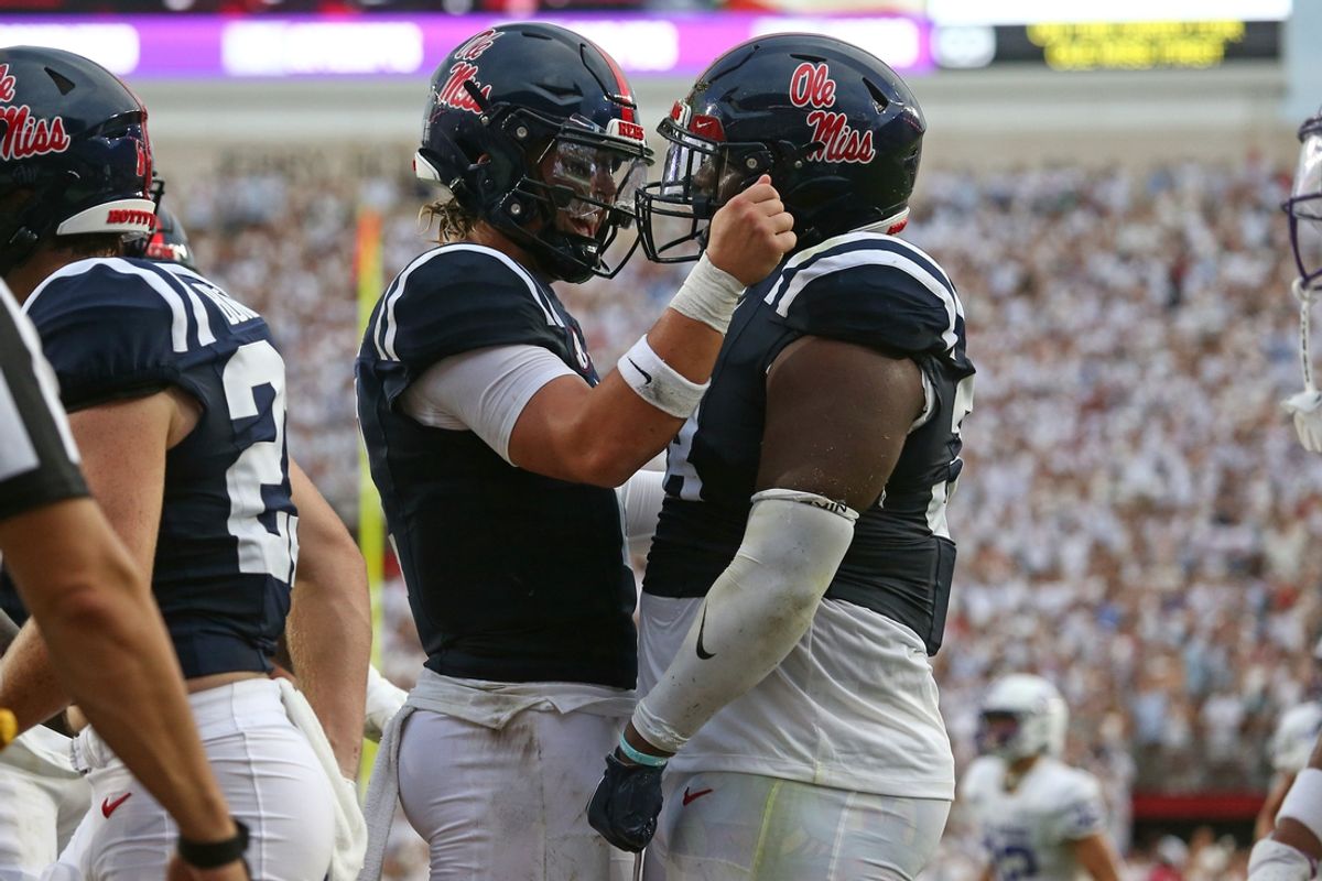 Aug 31, 2024; Oxford, Mississippi, USA; Mississippi Rebels quarterback Jaxson Dart (2) reacts with defensive linemen JJ Pegues (38) after a touchdown during the first quarter against the Furman Paladins at Vaught-Hemingway Stadium. Mandatory Credit: Petre Thomas-USA TODAY Sports