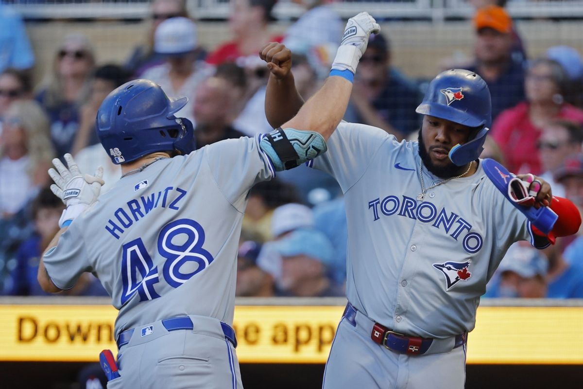 Aug 31, 2024; Minneapolis, Minnesota, USA; Toronto Blue Jays second baseman Spencer Horwitz (48) celebrates the two run home run against the Minnesota Twins with first baseman Vladimir Guerrero (27) in the first inning at Target Field. Mandatory Credit: Bruce Kluckhohn-USA TODAY Sports