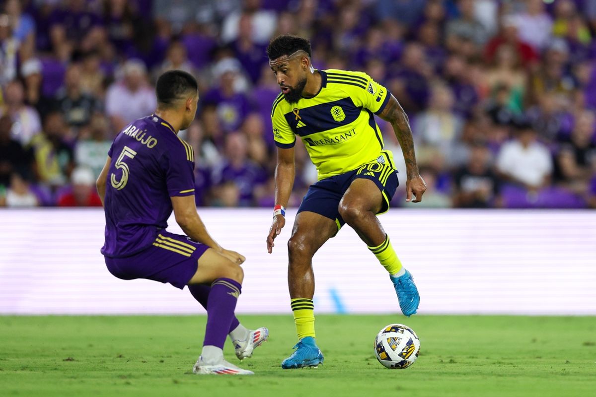 Aug 31, 2024; Orlando, Florida, USA; Nashville SC midfielder Anibal Godoy (20) controls the ball from Orlando City midfielder Cesar Araujo (5) in the first half at Inter&Co Stadium. Mandatory Credit: Nathan Ray Seebeck-USA TODAY Sports