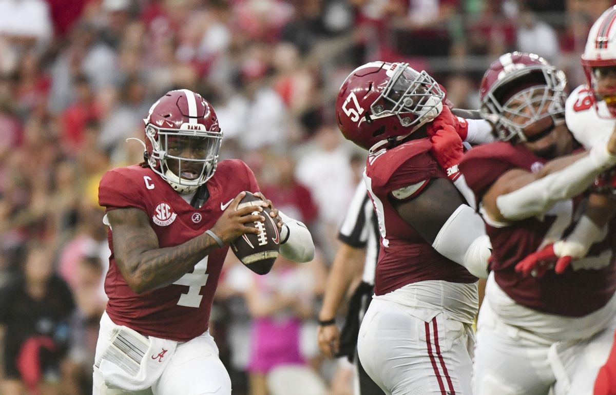 Aug 31, 2024; Tuscaloosa, Alabama, USA;  Alabama Crimson Tide quarterback Jalen Milroe (4) scrambles behind blocking by offensive lineman Elijah Pritchett (57) during the first half at Bryant-Denny Stadium.  Mandatory Credit: Gary Cosby Jr.-USA TODAY Sports