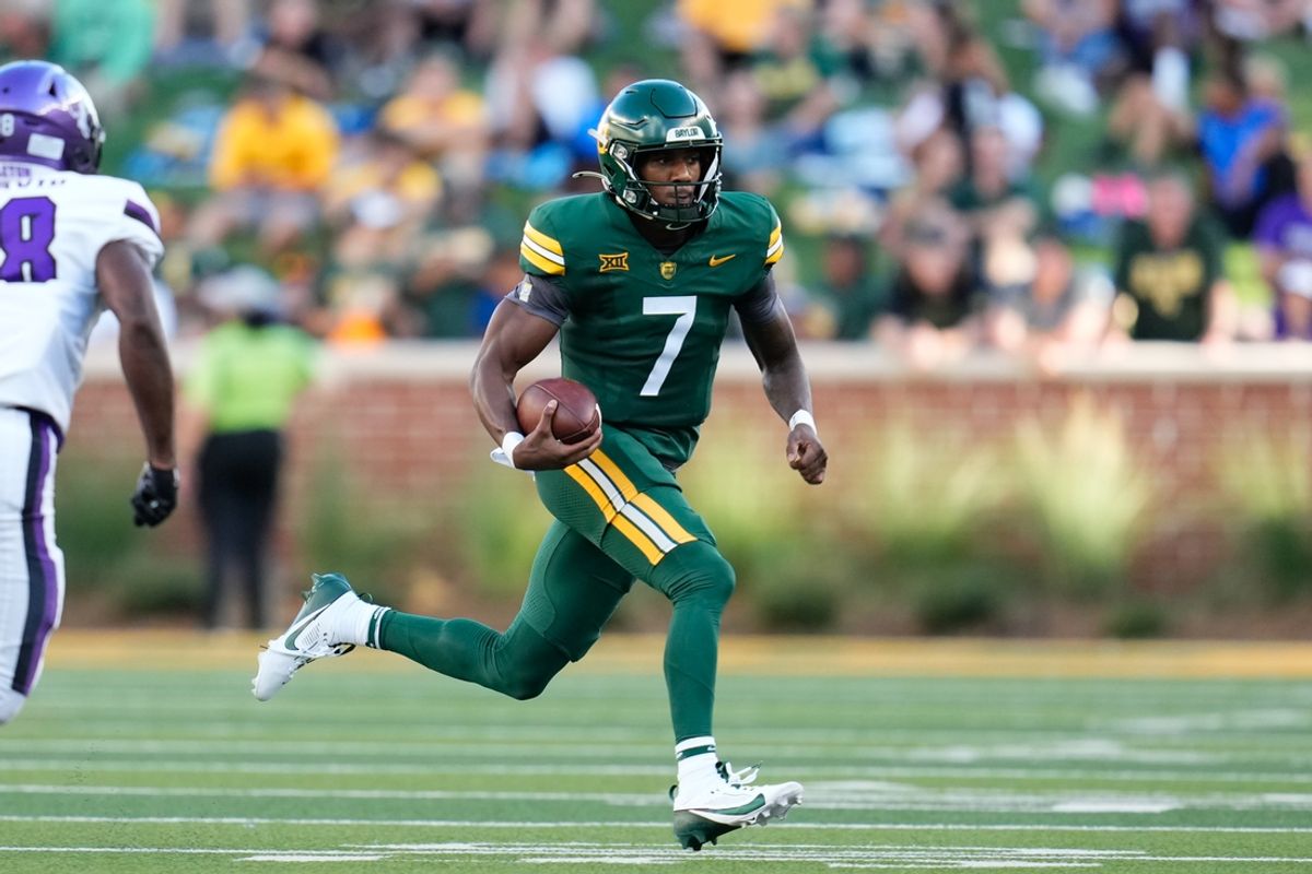 Aug 31, 2024; Waco, Texas, USA; Baylor Bears quarterback Dequan Finn (7) scrambles with the ball against the Tarleton State Texans during the first half at McLane Stadium. Mandatory Credit: Chris Jones-Imagn Images