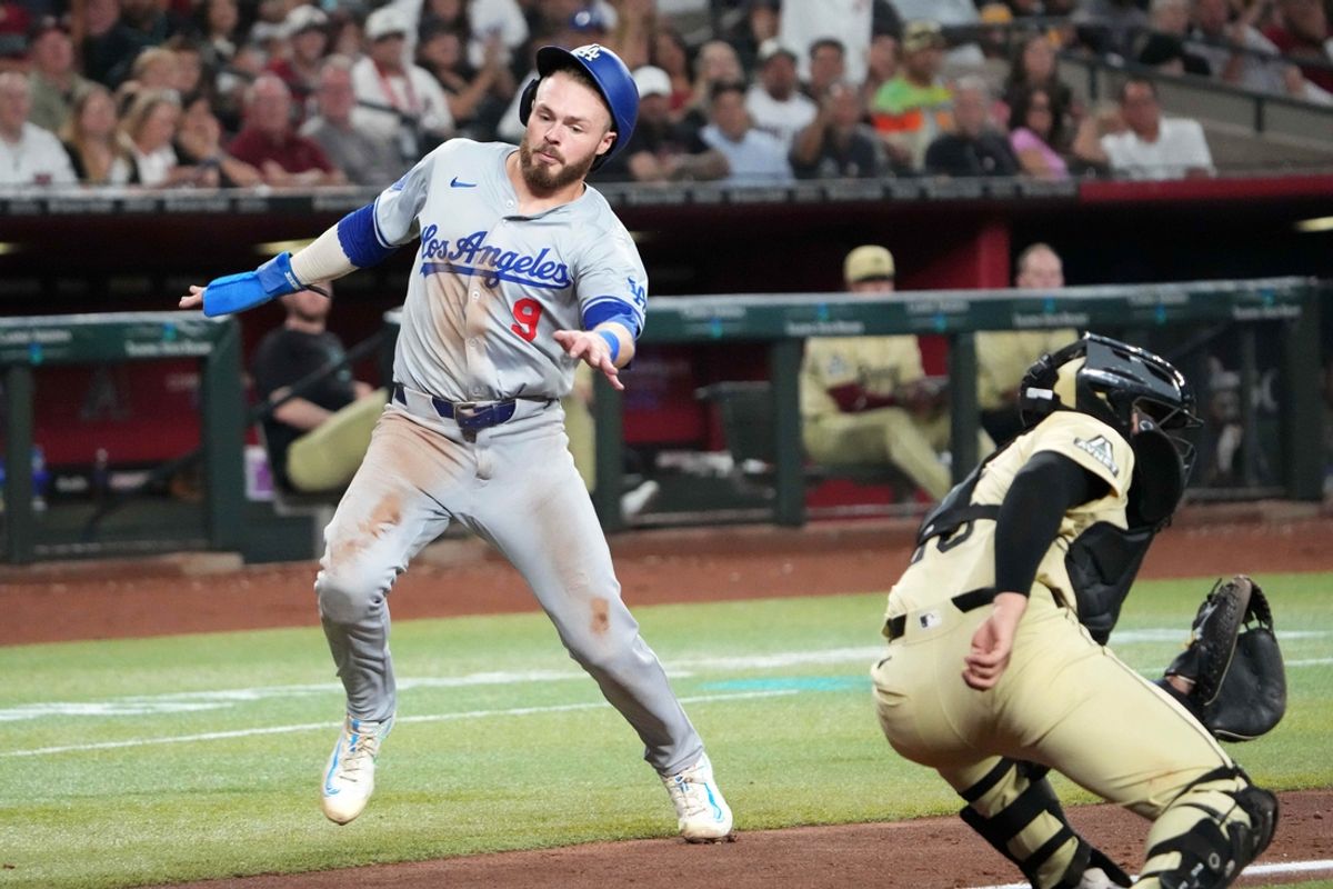 Aug 31, 2024; Phoenix, Arizona, USA; Los Angeles Dodgers second base Gavin Lux (9) beats a throw to Arizona Diamondbacks catcher Adrian Del Castillo (25) to score a run during the fifth inning at Chase Field. Mandatory Credit: Joe Camporeale-USA TODAY Sports