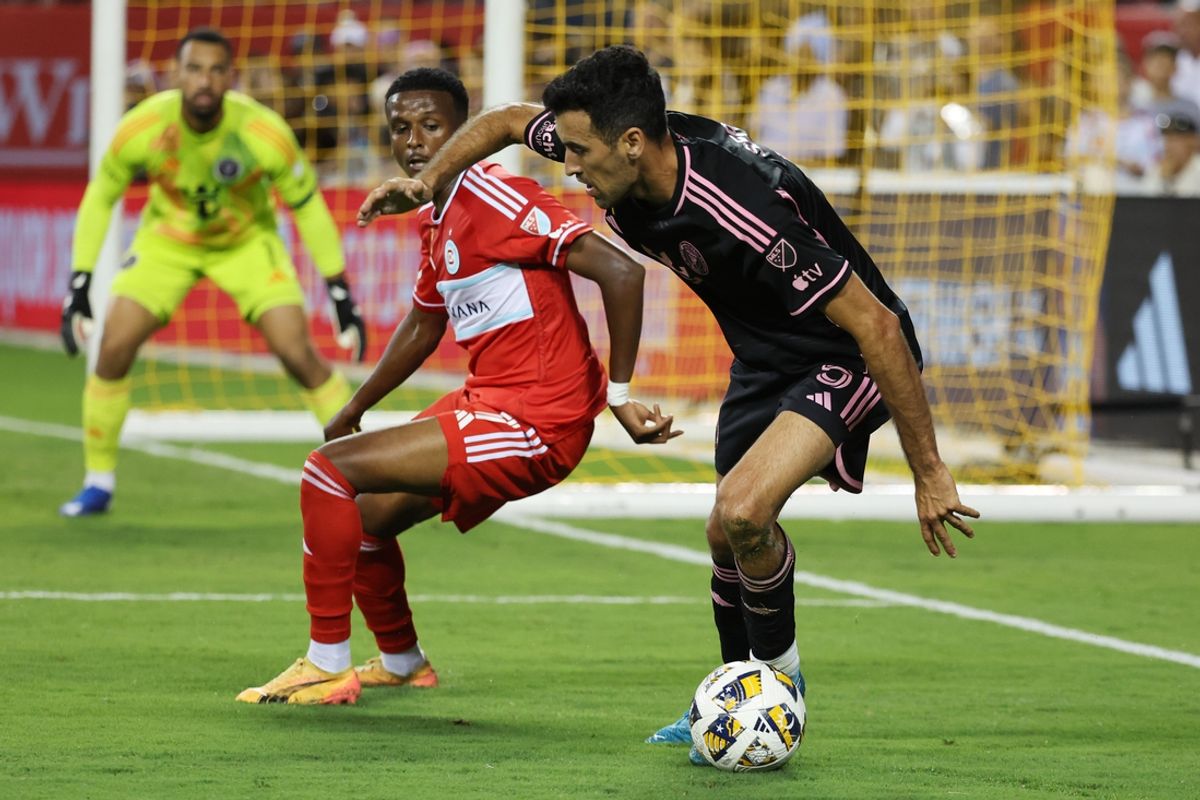Aug 31, 2024; Chicago, Illinois, USA; Inter Miami CF defender Sergio Busquets (5) controls the ball against Chicago Fire FC midfielder Maren Haile-Selassie (7) in the first half at Soldier Field. Mandatory Credit: Mike Dinovo-USA TODAY Sports