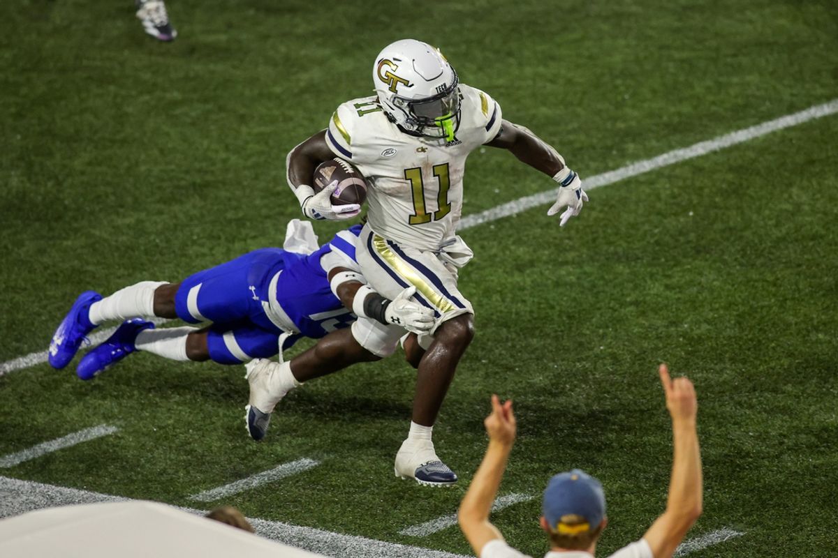 Aug 31, 2024; Atlanta, Georgia, USA; Georgia Tech Yellow Jackets running back Jamal Haynes (11) runs the ball past Georgia State Panthers safety Isaiah Holland (13) in the second quarter at Bobby Dodd Stadium at Hyundai Field. Mandatory Credit: Brett Davis-USA TODAY Sports