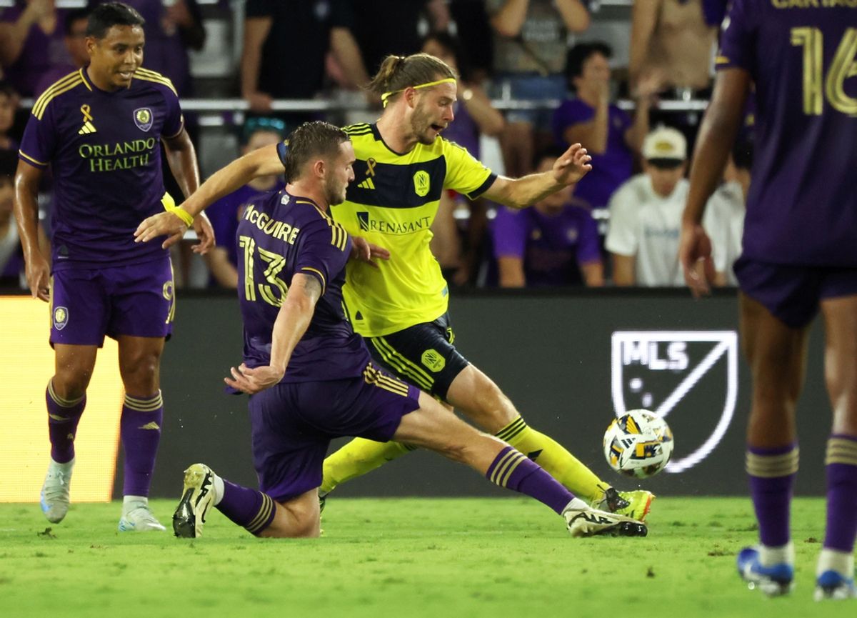 Aug 31, 2024; Orlando, Florida, USA;Orlando City forward Duncan McGuire (13) defends Nashville SC defender Walker Zimmerman (25)  during the second half at Inter&Co Stadium. Mandatory Credit: Kim Klement Neitzel-Imagn Images