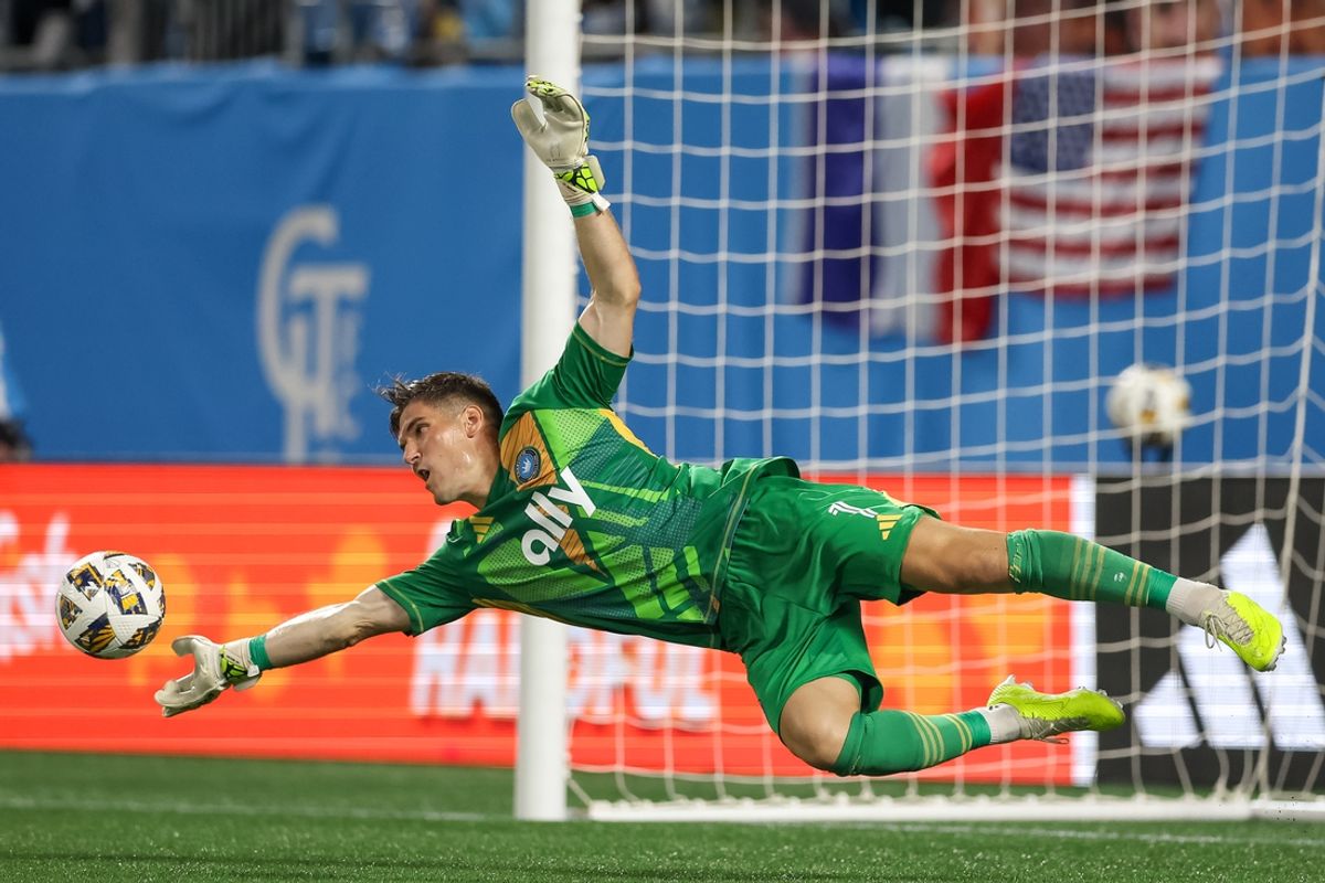 Aug 31, 2024; Charlotte, North Carolina, USA;  Charlotte FC goalkeeper Kristijan Kahlina (1) makes a diving save against Atlanta United during the second half at Bank of America Stadium. Mandatory Credit: Cory Knowlton-Imagn Images
