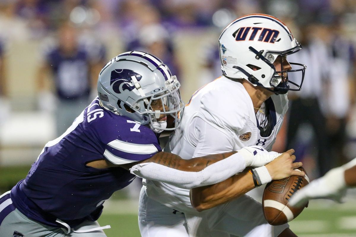 Aug 31, 2024; Manhattan, Kansas, USA; Kansas State Wildcats linebacker Kam Sallis (7) tries to strip the ball from Tennessee-Martin Skyhawks quarterback Kaiya Sheron (12) during the fourth quarter at Bill Snyder Family Football Stadium. Mandatory Credit: Scott Sewell-Imagn Images