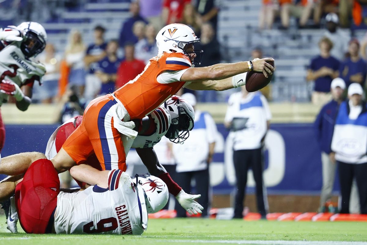 Aug 31, 2024; Charlottesville, Virginia, USA; Virginia Cavaliers quarterback Anthony Colandrea (10) scores a touchdown past Richmond Spiders linebacker Wayne Galloway (9) and Spiders defensive back Bryson Parker (4) during the second half at Scott Stadium. Mandatory Credit: Amber Searls-Imagn Images