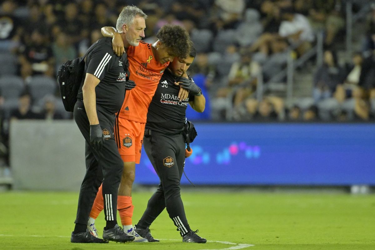 Aug 31, 2024; Los Angeles, California, USA; Houston Dynamo FC forward Lawrence Ennali (37) is helped off the field after an apparent injury against LAFC in the second half at BMO Stadium. Mandatory Credit: Jayne Kamin-Oncea-USA TODAY Sports