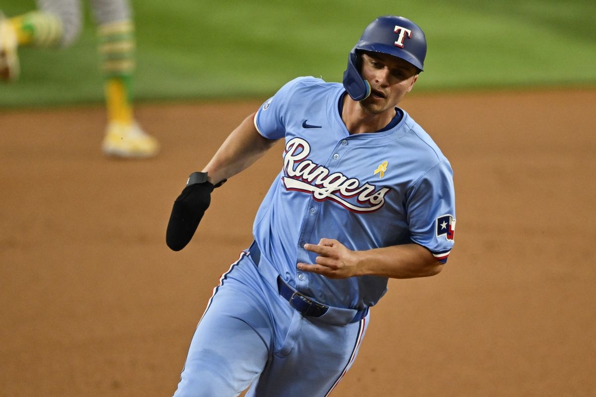 Sep 1, 2024; Arlington, Texas, USA; Texas Rangers shortstop Corey Seager (5) scores from second base on a double hit by right fielder Adolis Garcia (not pictured) during the first inning at Globe Life Field. Mandatory Credit: Jerome Miron-Imagn Images