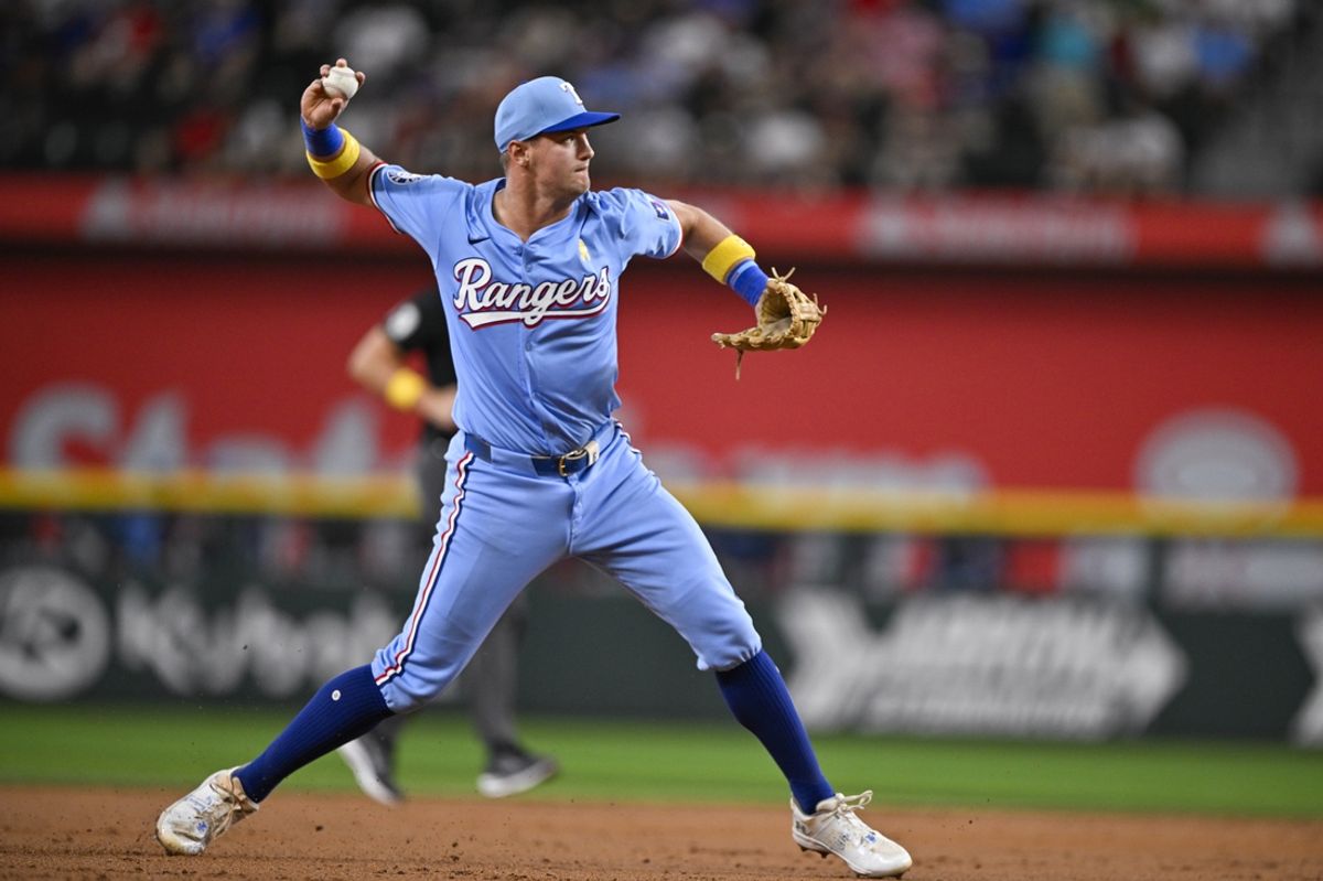 Sep 1, 2024; Arlington, Texas, USA; Texas Rangers third baseman Josh Jung (6) throws to first base during the third inning at Globe Life Field. Mandatory Credit: Jerome Miron-USA TODAY Sports