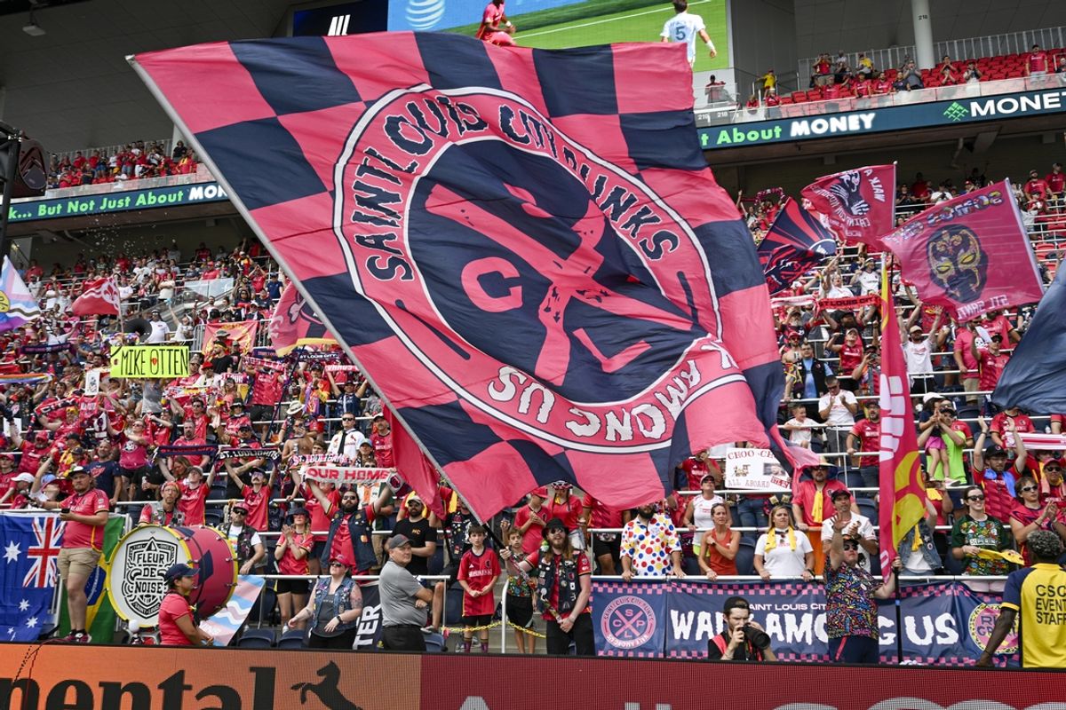 Sep 1, 2024; St. Louis, Missouri, USA; St. Louis CITY SC fans wave a flag after their win against the LA Galaxy at CITYPARK. Mandatory Credit: Scott Rovak-Imagn Images