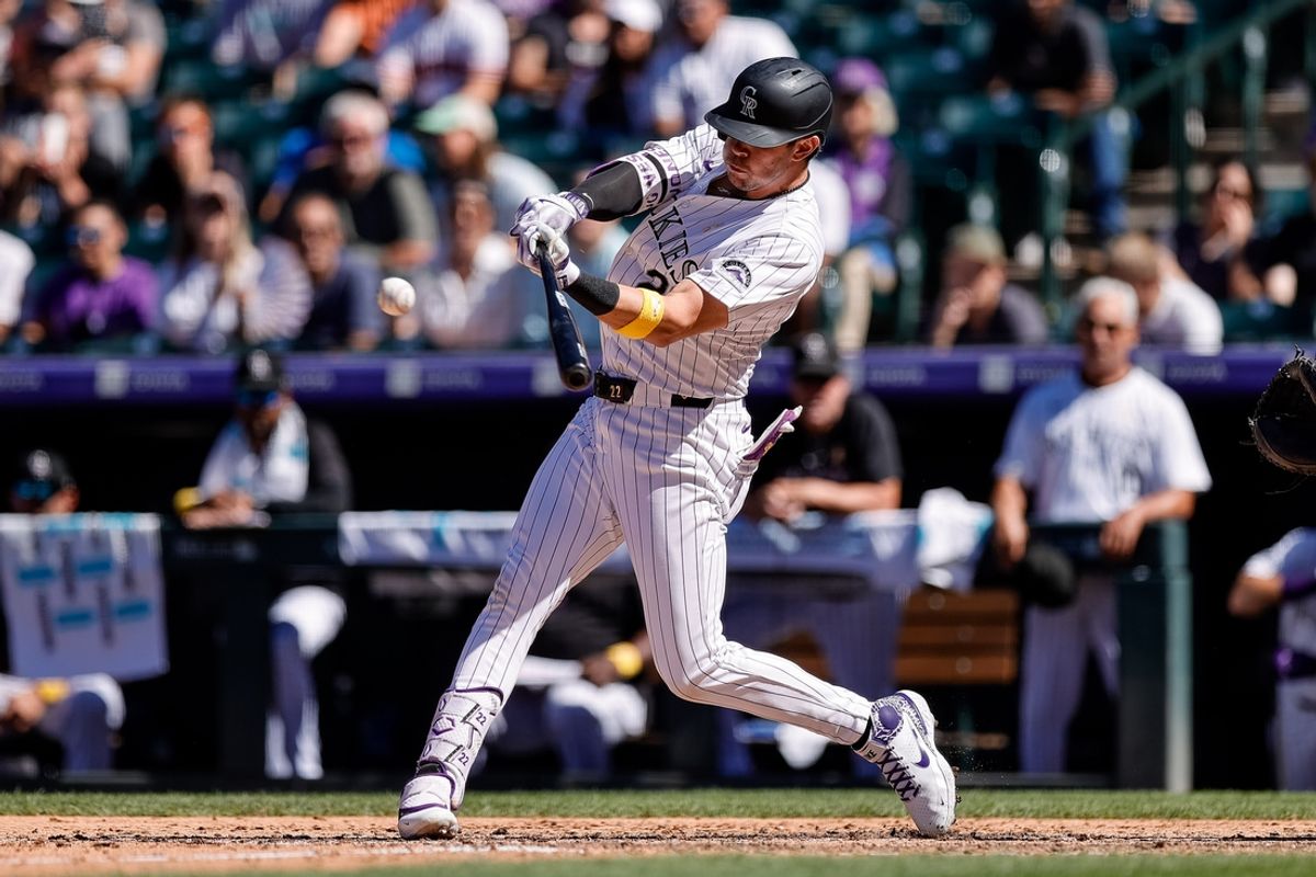 Sep 1, 2024; Denver, Colorado, USA; Colorado Rockies designated hitter Nolan Jones (22) hits an RBI single in the seventh inning against the Baltimore Orioles at Coors Field. Mandatory Credit: Isaiah J. Downing-USA TODAY Sports
