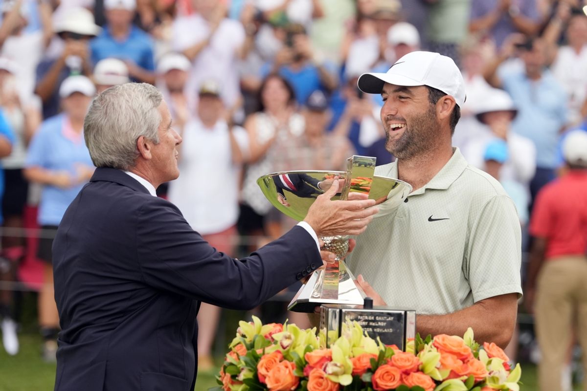 Sep 1, 2024; Atlanta, Georgia, USA; Sep 1, 2024; Atlanta, Georgia, USA; PGA TOUR Commissioner Jay Monahan presents Scottie Scheffler the FedEx Cup after winning the TOUR Championship golf tournament. Mandatory Credit: John David Mercer-Imagn Images