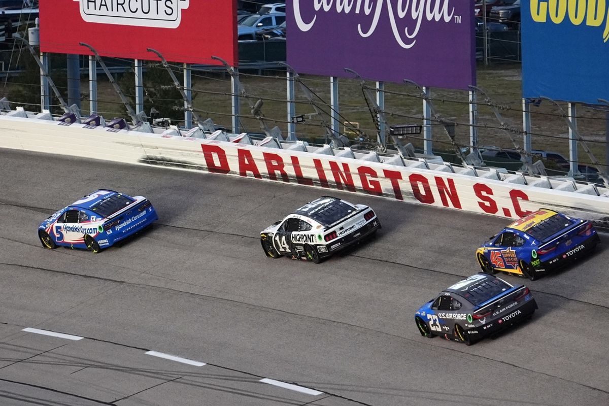 Sep 1, 2024; Darlington, South Carolina, USA; NASCAR Cup Series driver Kyle Larson (5) leads NASCAR Cup Series driver Chase Briscoe (14), NASCAR Cup Series driver Bubba Wallace (23) and NASCAR Cup Series driver Tyler Reddick (45) out of turn one during the Cook Out Southern 500 at Darlington Raceway. Mandatory Credit: Jasen Vinlove-USA TODAY Sports